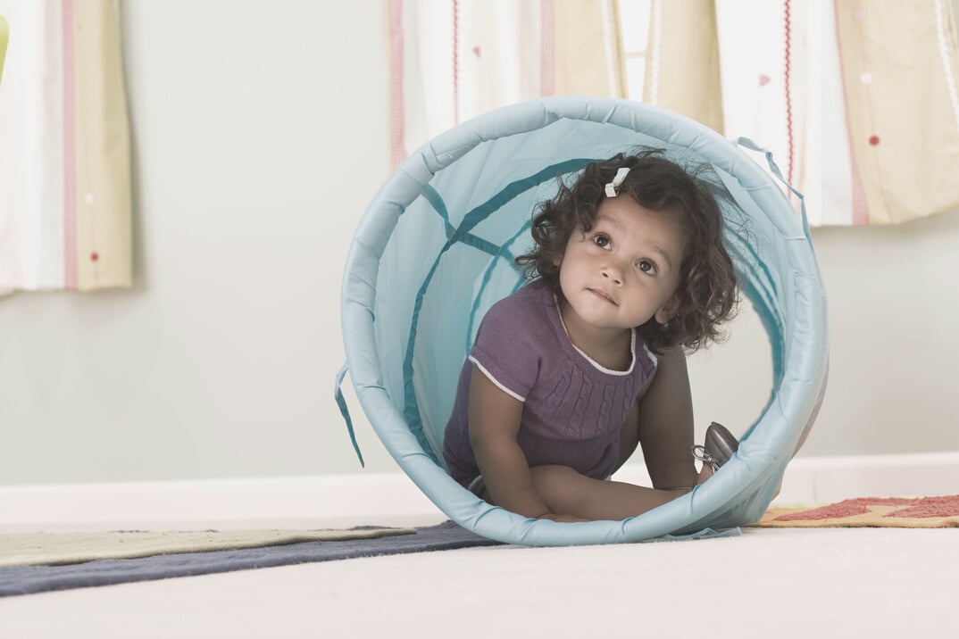 Toddler inside a toy tunnel